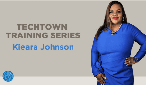 Women of color in a blue long sleeve dress representing the TechTown Training Series