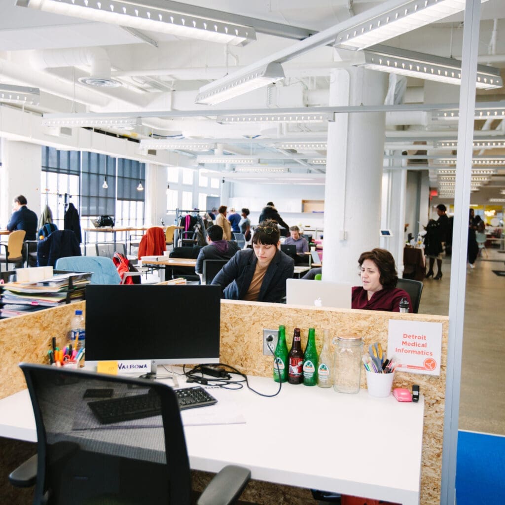 view of desk and busy office