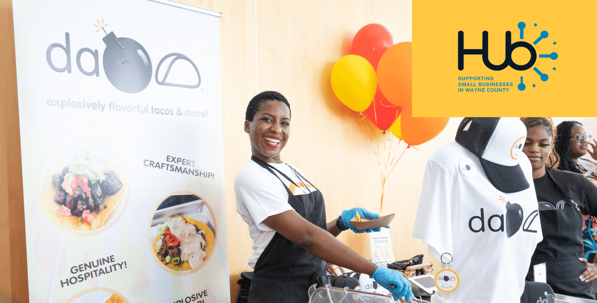 Entrepreneur smiling at the camera serving tacos